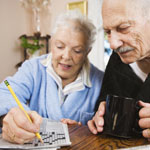 Senior couple doing crossword puzzle