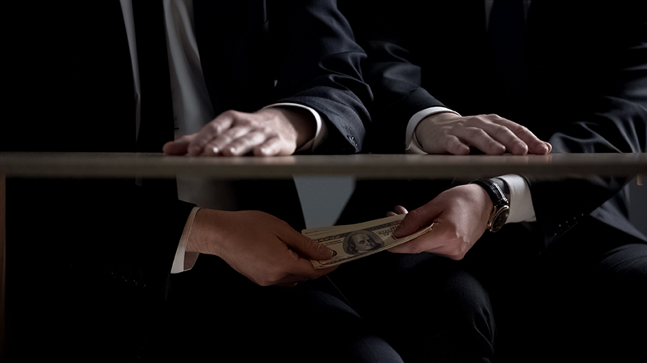 Politician hands taking bribe money under office table, lobbying
